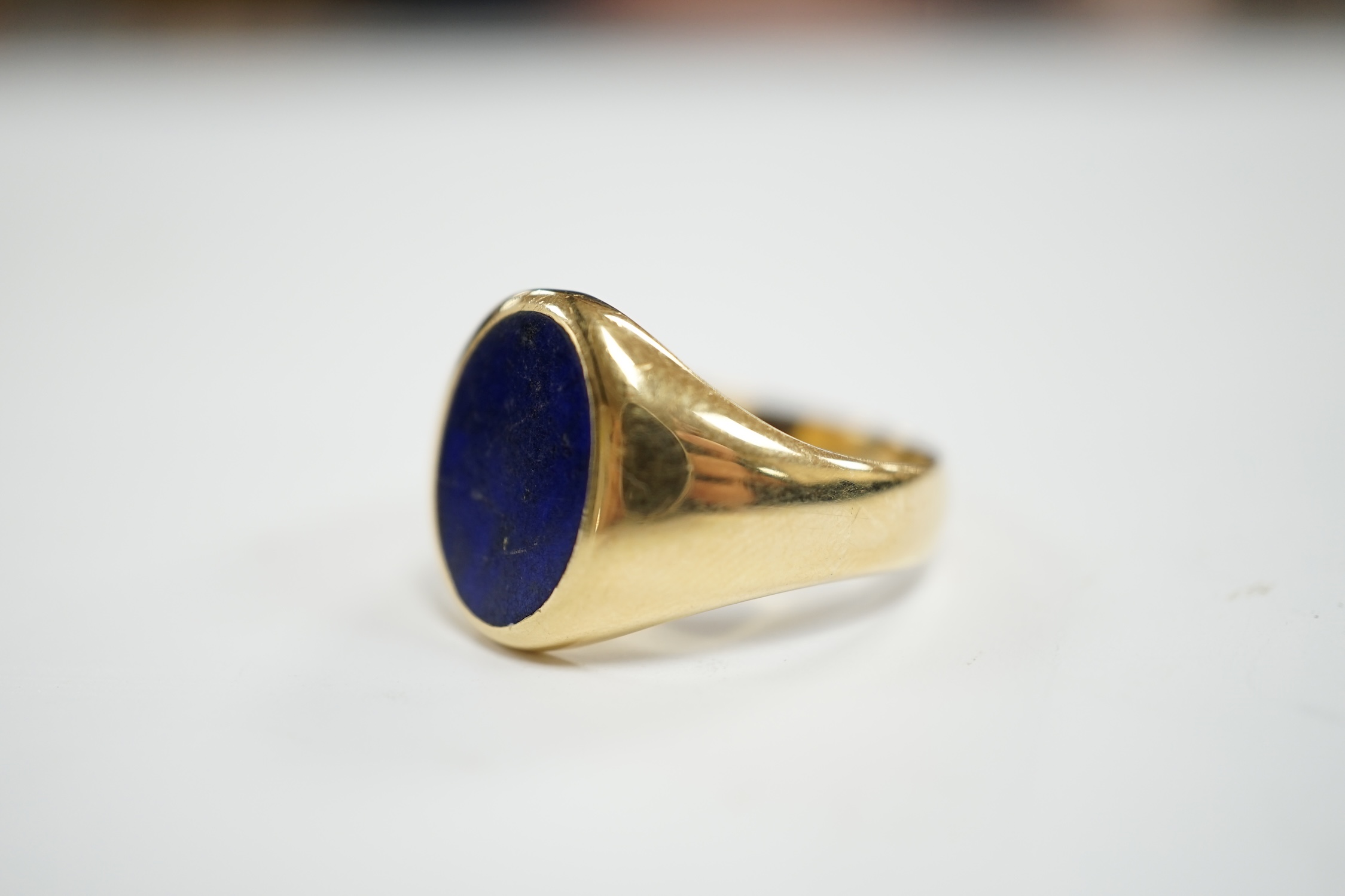 A George V 18ct gold and oval lapis lazuli set signet ring, hallmarked for Chester, 1915, size U, gross weight 8.5 grams.